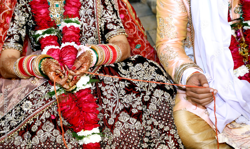 Indian bride and groom during Gath Bandhan ritual ceremony