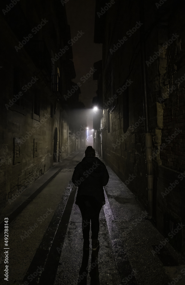 Woman in dark street