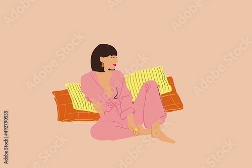Young brunette woman in pyjama sitting relaxed on pillows on beige background. Vector illustration
