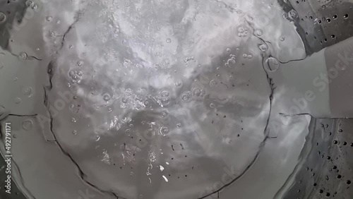 The washing machine is spinning and working in the washing machine.