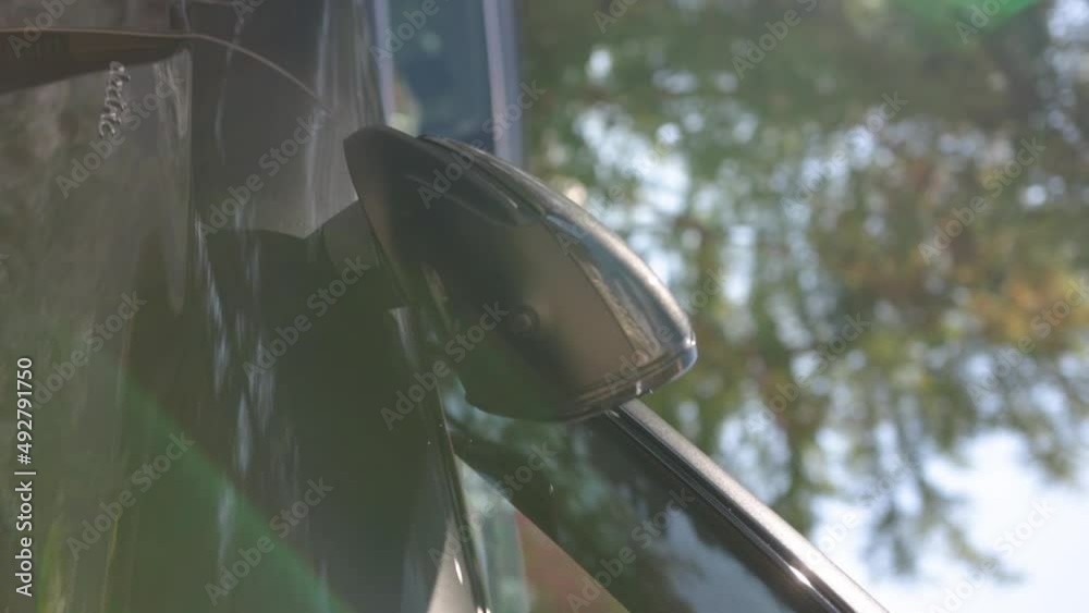 Modern luxurious EV mirror automatically closes after the engine is ...