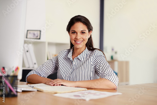 Im here to make it big in my career. Portrait of a confident young businesswoman sitting at her desk in an office.