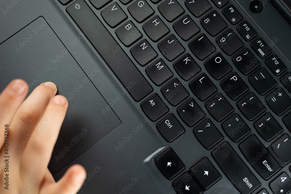 Young girl is typing on the keyboard. Risky behaviour of children in internet. Young girl is typing on the keyboard. Risky behaviour of children in internet.