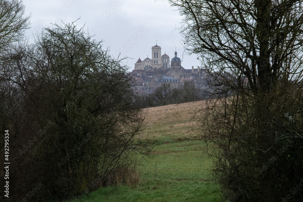 Vezelay, France - February 23 , 2022: Vezelay Abbey is a Benedictine and Cluniac monastery in the Bourgogne-Franche-Comte. Cloudy winter day. Selective focus. Vezelay, France - February 23 , 2022: Vezelay Abbey is a Benedictine and Cluniac monastery in the Bourgogne-Franche-Comte. Cloudy winter day. Selective focus.