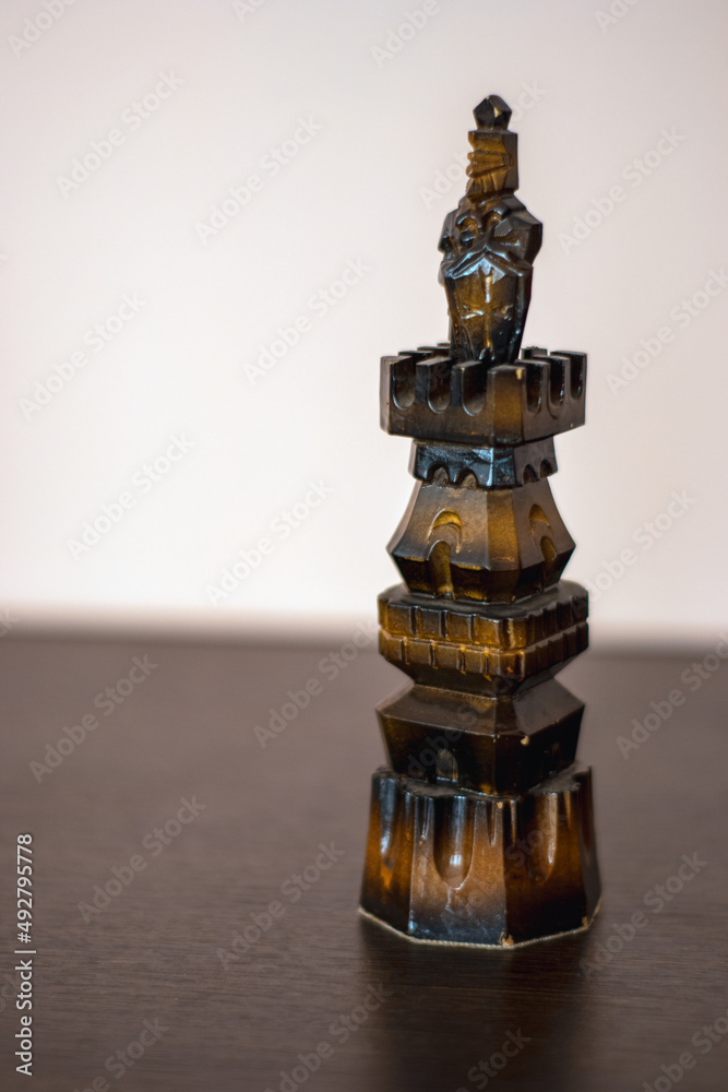 A Black figure stands on a table A Black figure stands on a table