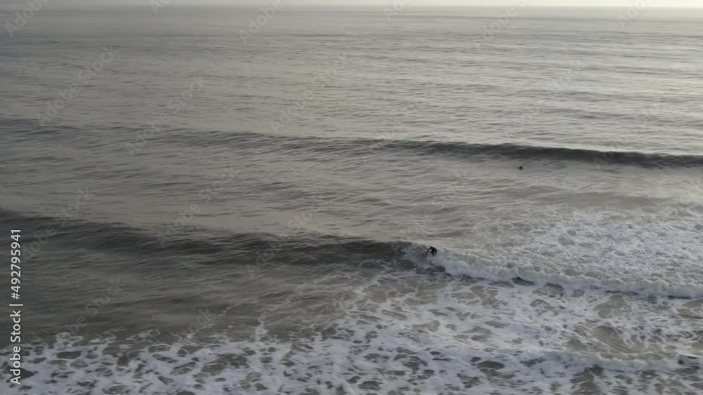 Drone shot of surfer riding wave Drone shot of surfer riding wave
