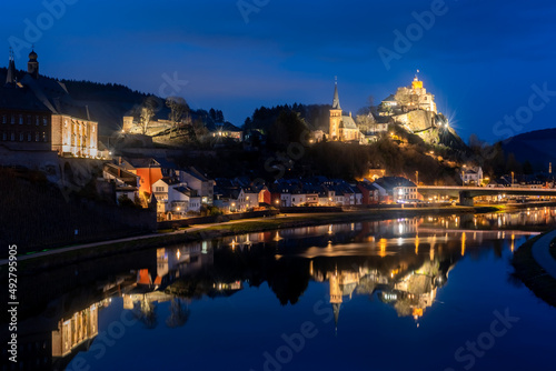 Saarburg panorama in Rhineland-Palatinate near Trier Germany and Luxemburg is a small touristic town with medieval centre. Blue hour twilight atmosphere with lights mirrored in River Saar.