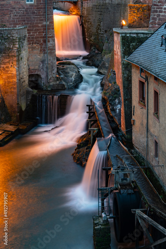 Saarburg in Rhineland-Palatinate near Trier, Luxemburg and Saarbrucken is a small touristic town on River Saar with medieval centre and waterfall drop used for mills. Blue hour atmosphere with lights. © ON-Photography