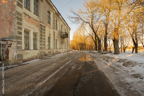 An old, abandoned building. Spring day, puddles on the streets © M.V.schiuma
