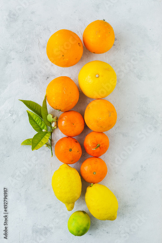 Oranges, tangerines and lemons in overhead view on vintage background
