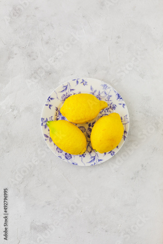 Vintage plate with lemons on vintage white background