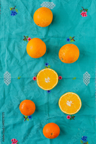 Overhead view of oranges with vintage turquoise background