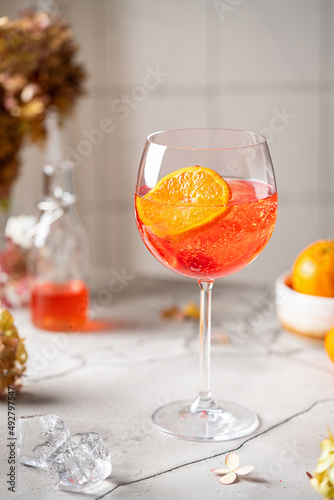 Italian Aperol Spritz cocktail with orange slices on gray stone table. Summer drink, homemade sangria. Copy space
