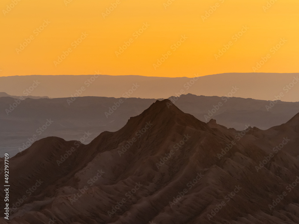 Stunning sunset in the Valle de la Luna (Valley of the Moon), San Pedro de Atacama, Chile. Amazing rock formations, deep canyons and cliffs, huge sand dunes with infinite color and texture variations.