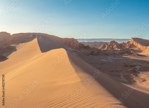 Stunning desert landscapes in the Valley of Moon (Valle de la Luna), San Pedro de Atacama, Chile. Unique rock formations, cliffs sand dunes with infinite color and texture variations. photo