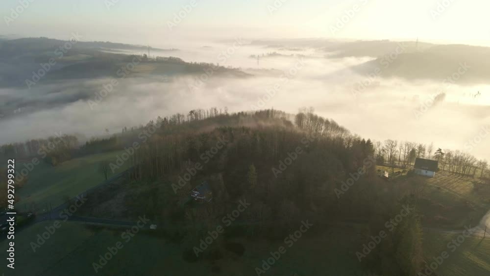 Overwhelming panorama over Morsbach, Germany during a foggy winter sunrise. Aerial fly-over push in movement Overwhelming panorama over Morsbach, Germany during a foggy winter sunrise. Aerial fly-over push in movement