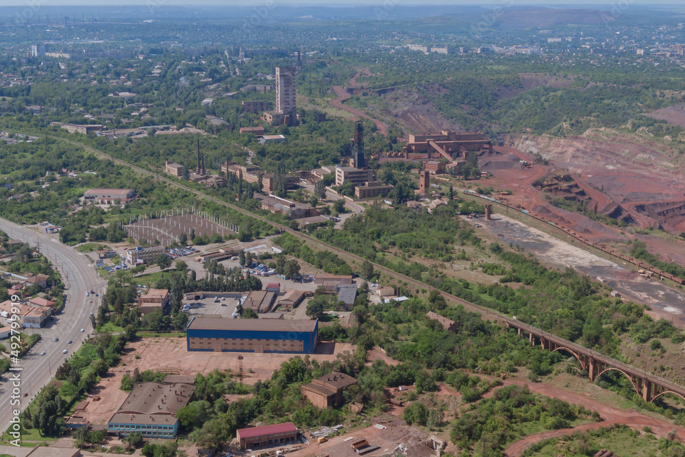 Red quarry, mountains, nature from a height of flight. Panoramic view of the industrial city of Krivoy Rog in Ukraine.