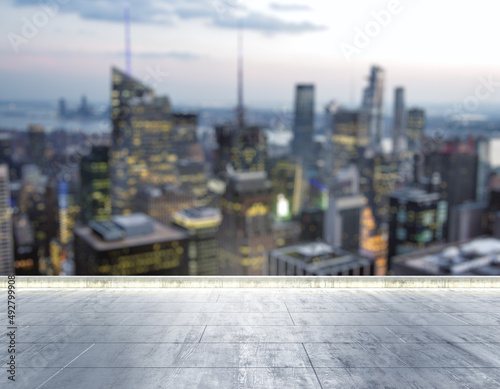 Empty concrete dirty rooftop on the background of a beautiful blurry NY city skyline at night, mock up © Pixels Hunter