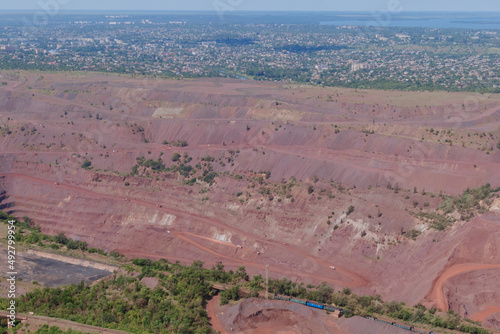 Red quarry, mountains, nature from a height of flight. Panoramic view of the industrial city of Krivoy Rog in Ukraine.