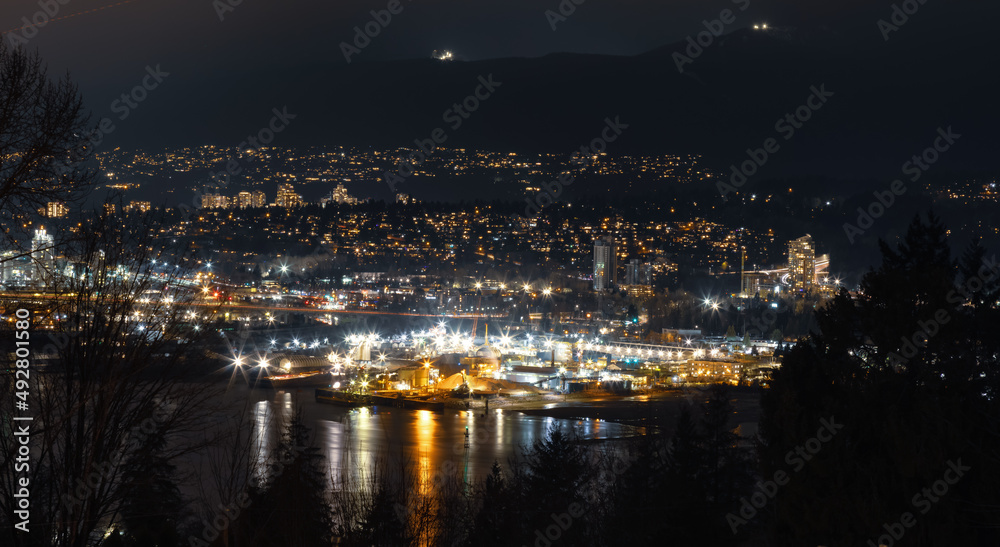 Fototapeta premium Modern Cityscape at Night with buildings and mountain in background. Taken from Capitol Hill in Burnaby, Vancouver, British Columbia, Canada.