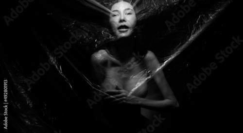 Obraz na plátně Nudity Slim woman emotionally posing, wrapped close to the fresh and fitting her