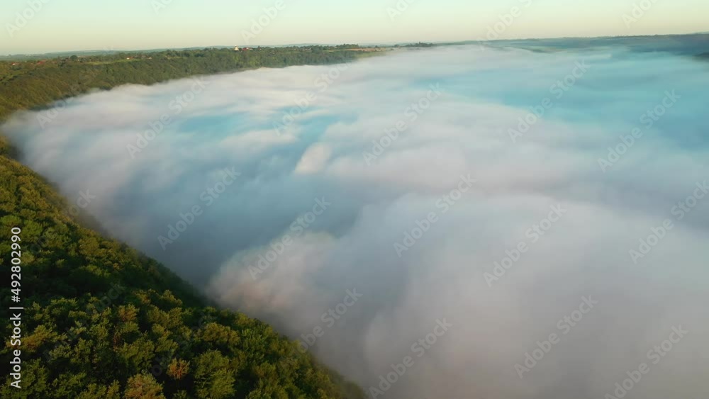 Great view of the valley covered with fluffy thick fog. Filmed in UHD 4k video. Great view of the valley covered with fluffy thick fog. Filmed in UHD 4k video.