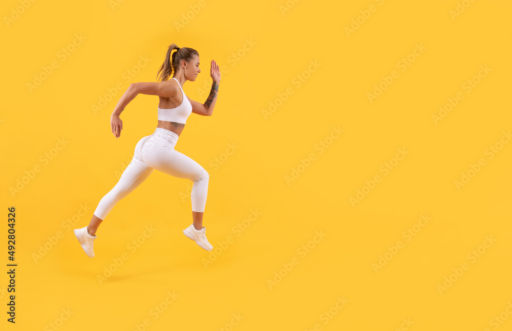 sport girl runner running with copy space on yellow background
