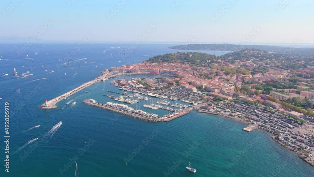 Saint-Tropez, France: Aerial view of city on French Riviera during regatta Les Voiles de Saint-Tropez, famous marina and lot of yachts and sailboats on Mediterranean Sea - landscape panorama of Europe Saint-Tropez, France: Aerial view of city on French Riviera during regatta Les Voiles de Saint-Tropez, famous marina and lot of yachts and sailboats on Mediterranean Sea - landscape panorama of Europe