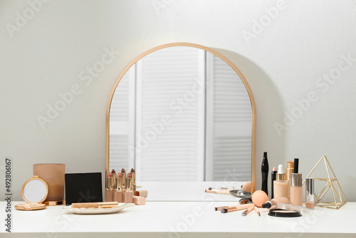 Quadro su tela Stylish mirror on dressing table with cosmetic products