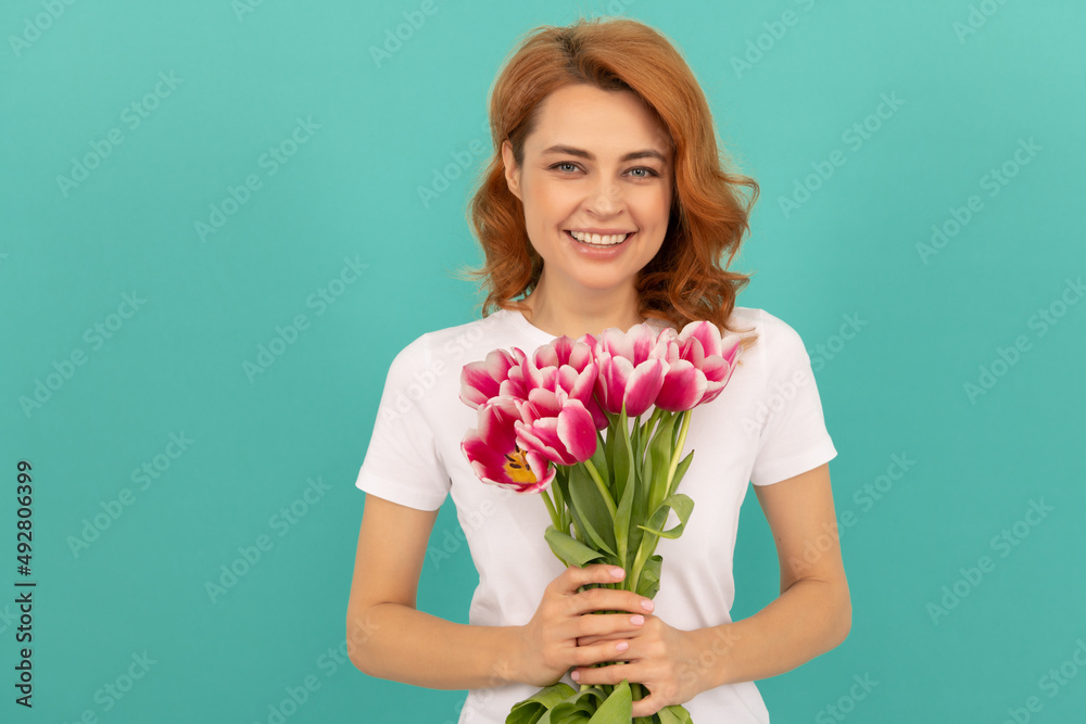 laughing woman with tulip flower bouquet on blue background laughing woman with tulip flower bouquet on blue background