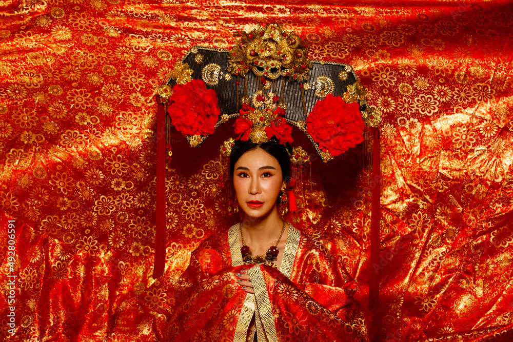 Asian Woman wear China Royal empress traditional costume with golden line  design dress and headwear Stock Photo | Adobe Stock