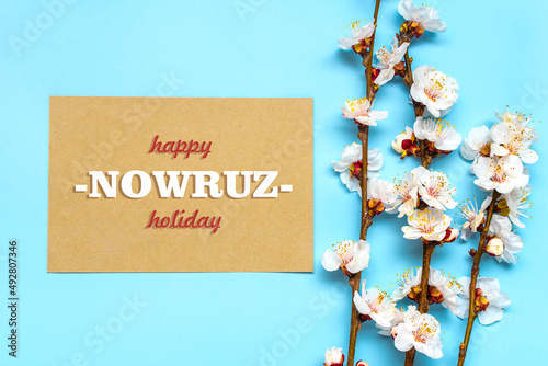 prigs of the apricot tree with flowers and Text Happy Nowruz Holiday Concept of spring came Top view Flat lay Hello march, april, may, persian new year	 photo