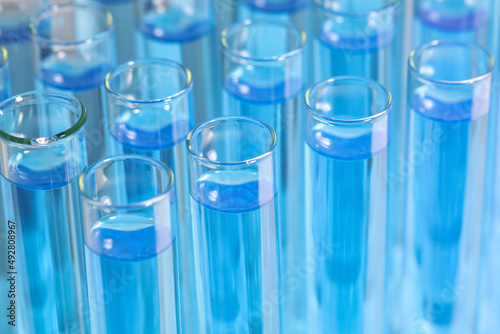 Test tubes with light blue reagents, closeup. Laboratory analysis