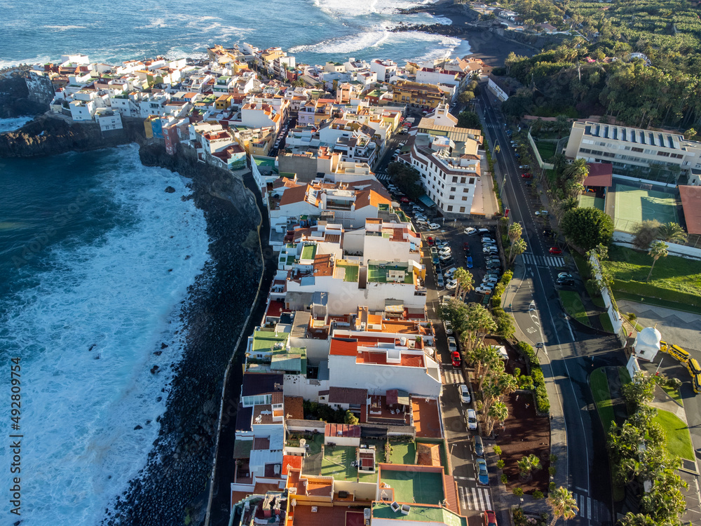 Aerial view on colorful houses and black lava rocks in small village Punta Brava near Puerto de la Cruz, Tenerife, Canary islands at sunrise Aerial view on colorful houses and black lava rocks in small village Punta Brava near Puerto de la Cruz, Tenerife, Canary islands at sunrise