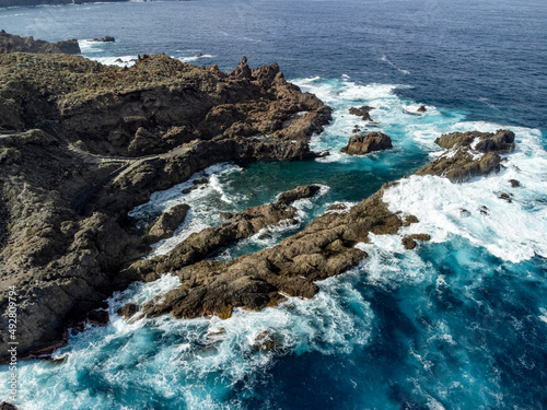 Aerial view on Charco del Viento natural pool in black lava rocks on Tenerife, Canary islands, Spain