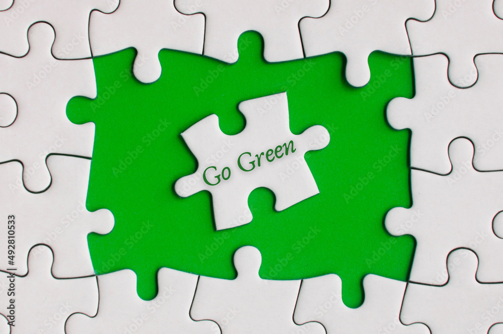 Go green text on jigsaw puzzle. Nature Concept Go green text on jigsaw puzzle. Nature Concept
