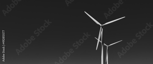 white wind turbines on black background © Anselm