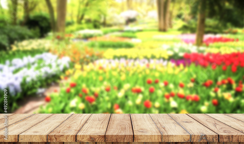 Wooden board empty table blurred garden background used for display products