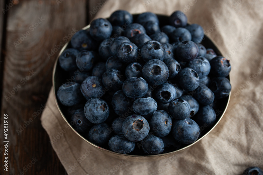 Bowl of fresh blueberries on rustic wooden table with copy space. Bowl of fresh blueberries on rustic wooden table with copy space.