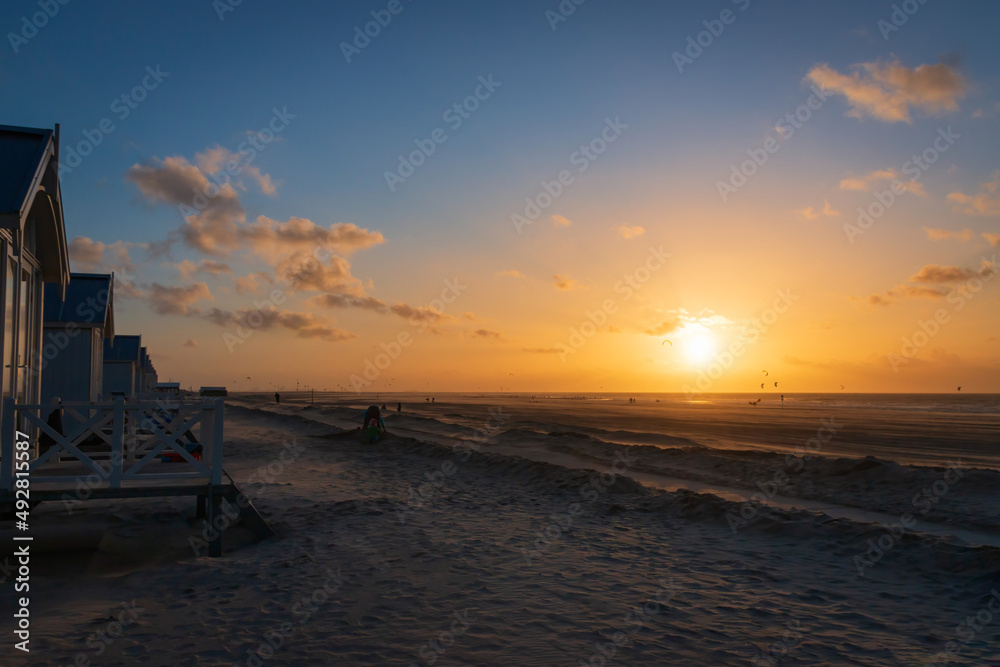 Beach huts at North Sea beach in Kijkduin, Netherlands at sunset