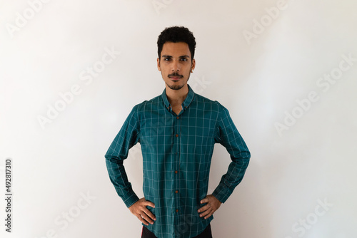 Black man in a social shirt in the studio isolated on yellow background. Isolated businessman with dramatic light.