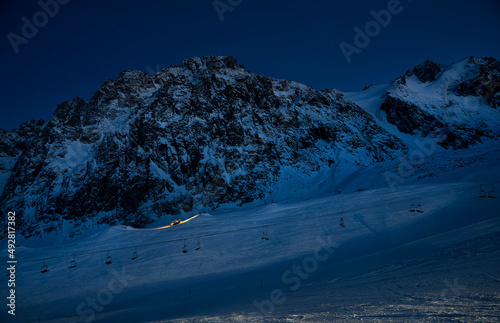 Snowcat ratrack at Shymbulak mountain ski resort at night photo