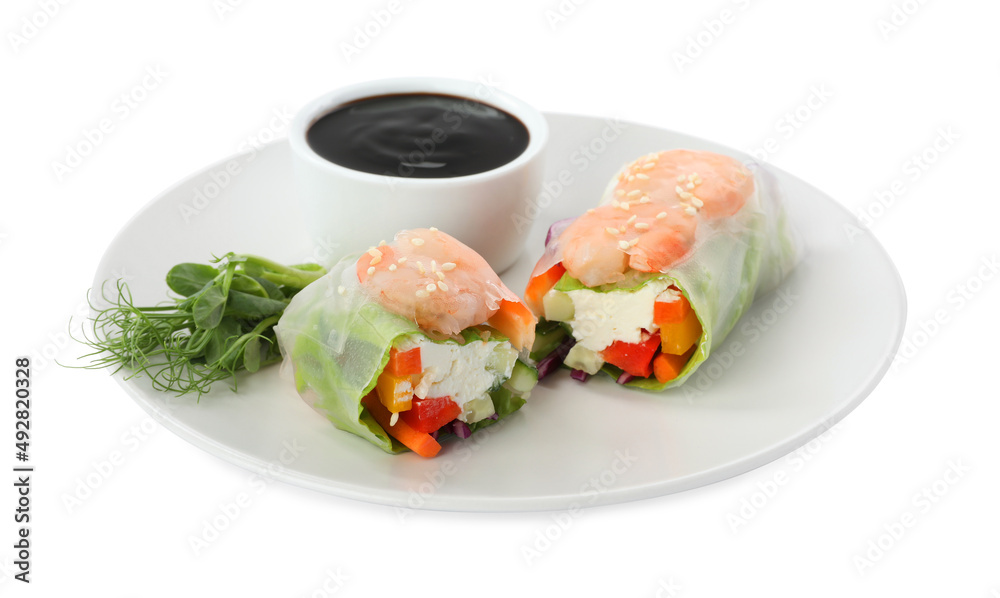 Plate with delicious roll wrapped in rice paper and teriyaki sauce on white background Plate with delicious roll wrapped in rice paper and teriyaki sauce on white background