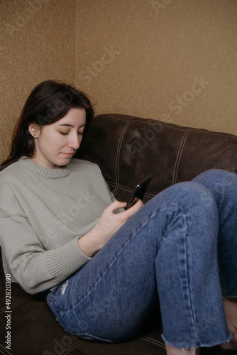 ukrainian woman freelancer working with phone at home