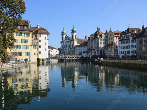 Beautiful old buildings reflecting in the Reuss, river in Lucerne, Switzerland.