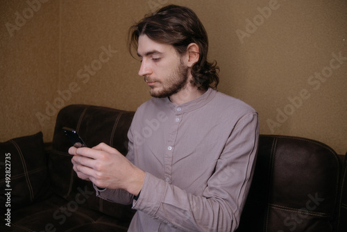 ukrainian man freelancer working with phone at home
