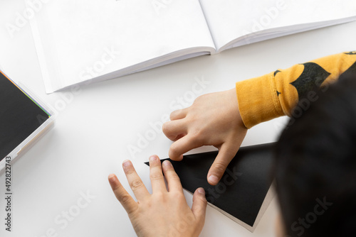 Child's hands folding paper