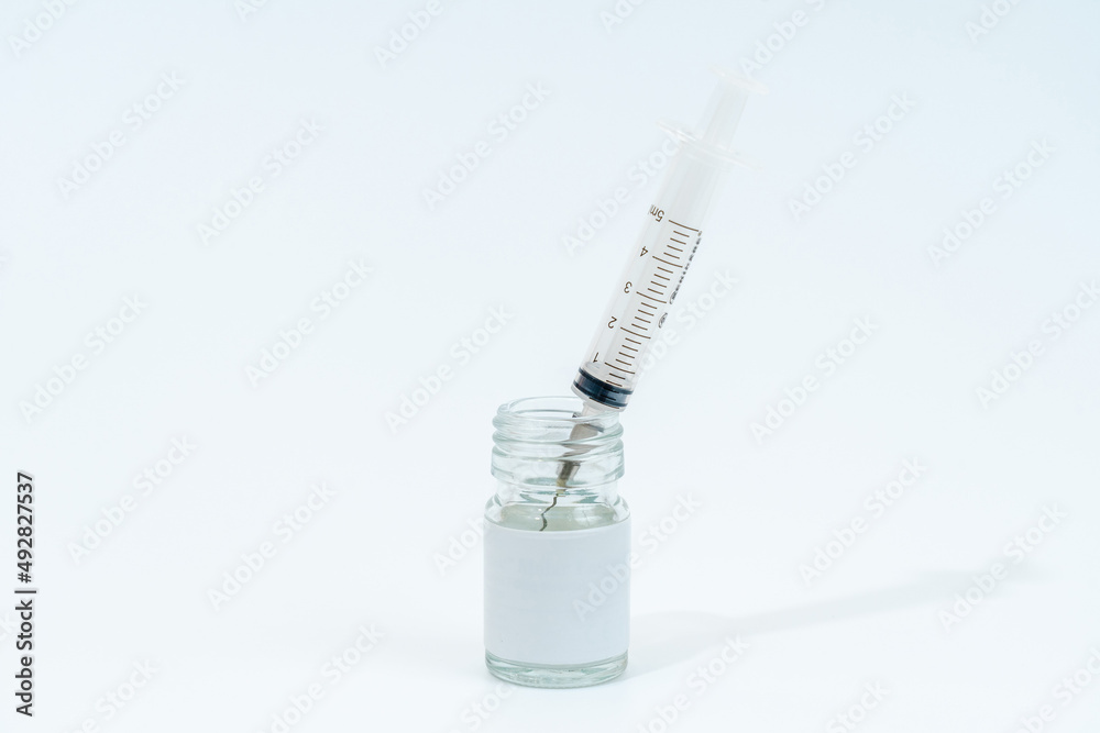 Medical glass bottle with syringe isolated on white background Medical glass bottle with syringe isolated on white background