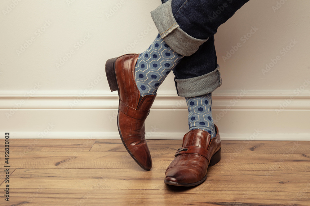 Splash Datum slack Studio photo of a pair of men's feet wearing a pair of blue patterned  socks, brown leather shoes, and jeans that are rolled up. Stock Photo |  Adobe Stock