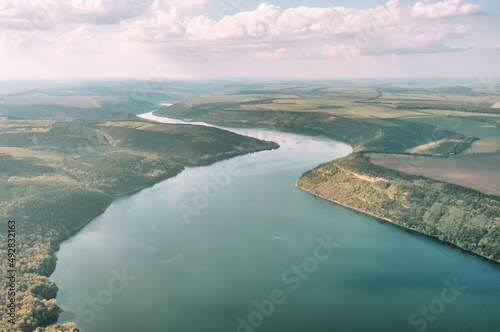 Magnificent aerial view on small tributary of the Dniester River with picturesque shores. National Nature Park Podilski Tovtry, the Dniester River, Ukraine. Beautiful view from flying drone.